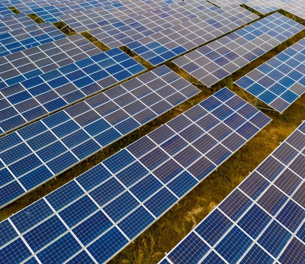 A large field of solar panels with no one in it.